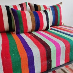 Cushions from colorful Moroccan floor sofa – artisan pillows with rainbow stripes for eclectic boho homes