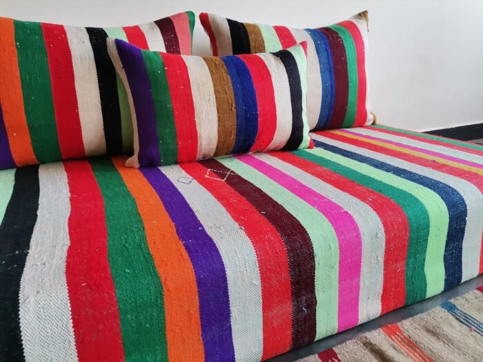 Cushions from colorful Moroccan floor sofa – artisan pillows with rainbow stripes for eclectic boho homes