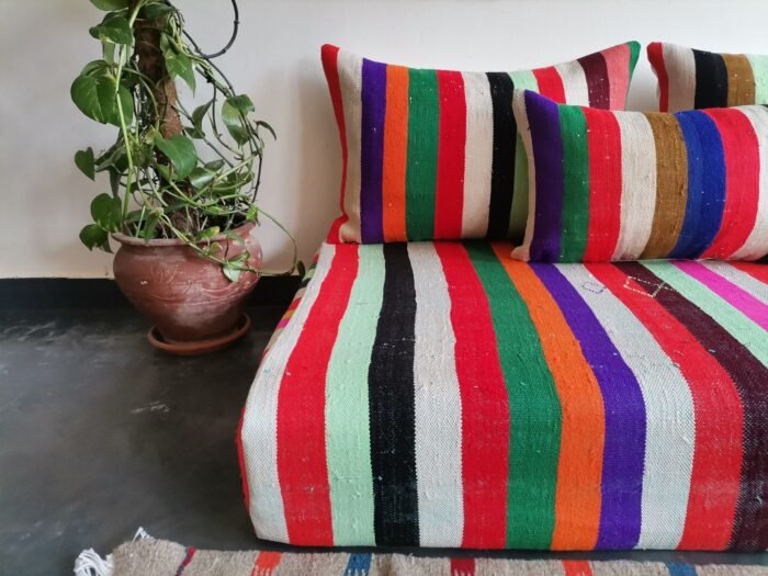 Cushions from colorful Moroccan floor sofa – artisan pillows with rainbow stripes for eclectic boho homes