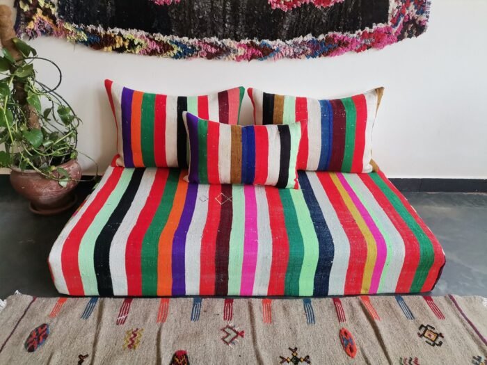 Top-down view of Moroccan wool couch in multiple vibrant stripes – handmade low seating for lively interiors