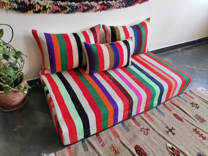 Left image of Moroccan artisan wool sofa with multicolor design – perfect for artistic boho living rooms