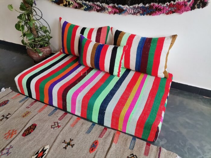 Right view of colorful Moroccan handmade wool sofa – artisan low couch with rainbow stripe pattern