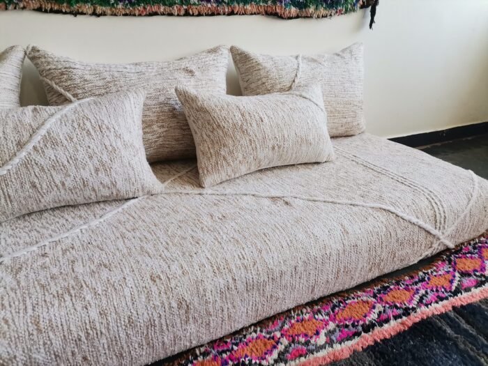 Left view of Moroccan floor sofa in cream with beige patterns – artisan piece perfect for boho-chic and rustic homes