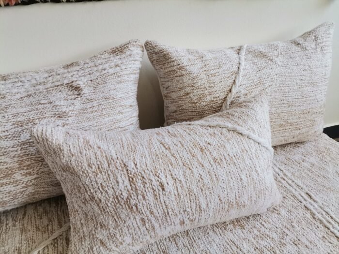 Close-up of cream cushions with beige patterns – Moroccan handmade covers for boho-chic decor