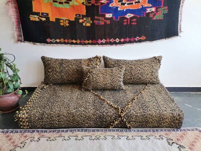 Top view of Moroccan floor sofa with black and mustard tones – artisan seating for strong, stylish interiors