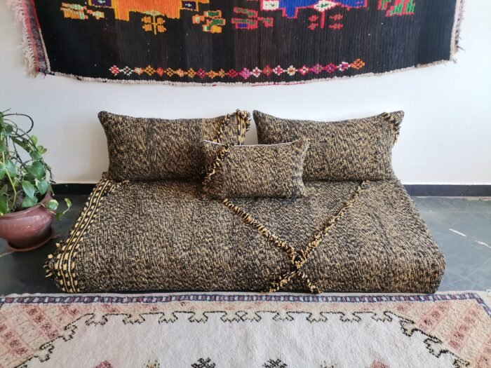 Close-up of mixed black and mustard cushions – handwoven Moroccan covers for cozy and stylish floor setups