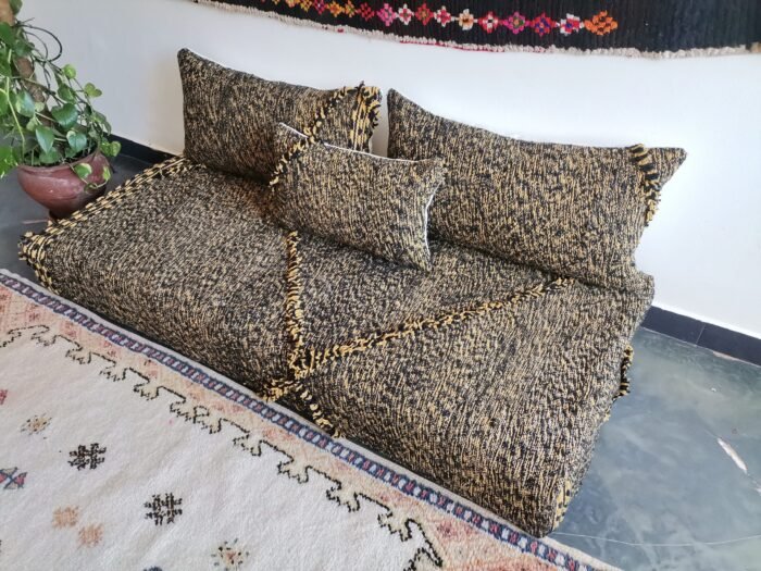 Right angle of Moroccan handmade sofa in black with mustard mix – bold floor seating for boho or industrial interiors