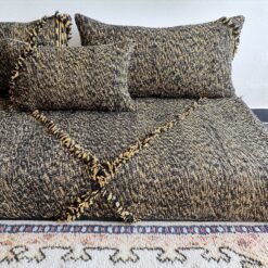 Close-up of mixed black and mustard cushions – handwoven Moroccan covers for cozy and stylish floor setups