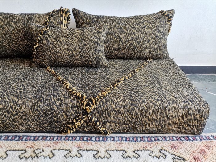 Close-up of mixed black and mustard cushions – handwoven Moroccan covers for cozy and stylish floor setups