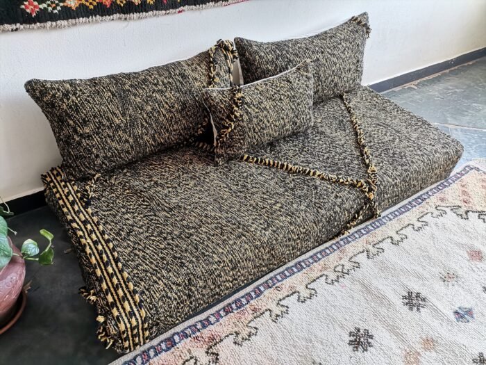 Top view of Moroccan floor sofa with black and mustard tones – artisan seating for strong, stylish interiors