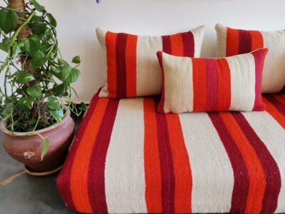 Cushions from Moroccan wool floor couch in cream with red and orange stripes – handcrafted pillow covers for modern bohemian and cozy living rooms