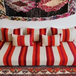 Main image of handmade Moroccan wool floor sofa in cream with red and orange stripes – artisan low seating with cushion cover set for cozy boho living rooms in the USA, UK, and Australia