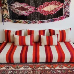 Main image of handmade Moroccan wool floor sofa in cream with red and orange stripes – artisan low seating with cushion cover set for cozy boho living rooms in the USA, UK, and Australia
