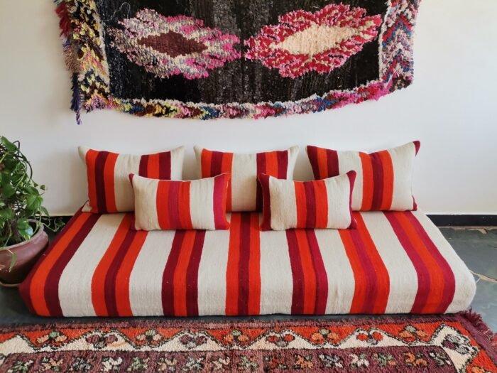 Main image of handmade Moroccan wool floor sofa in cream with red and orange stripes – artisan low seating with cushion cover set for cozy boho living rooms in the USA, UK, and Australia