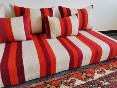 Cushions from Moroccan wool floor couch in cream with red and orange stripes – handcrafted pillow covers for modern bohemian and cozy living rooms