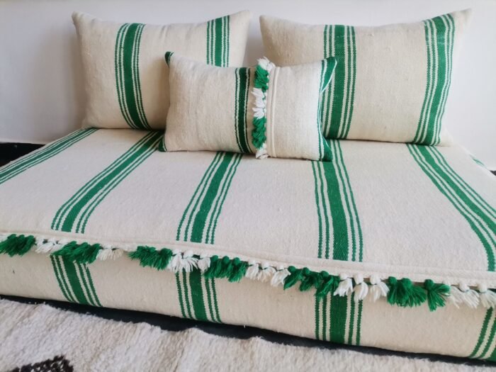 Cushions from Moroccan sofa in cream with green stripes and pom-pom detail – artisan wool pillows for joyful boho decor
