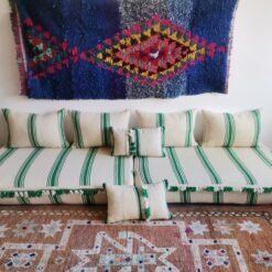 Moroccan wool floor sofa in cream with green stripes and pom-pom trim – handmade low seating for playful boho interiors
