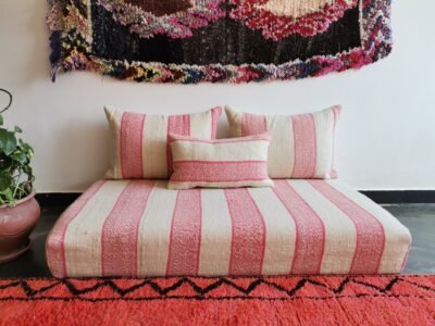 Moroccan handwoven wool floor sofa in cream with light pink blend – artisan seating with cushions for feminine cozy interiors