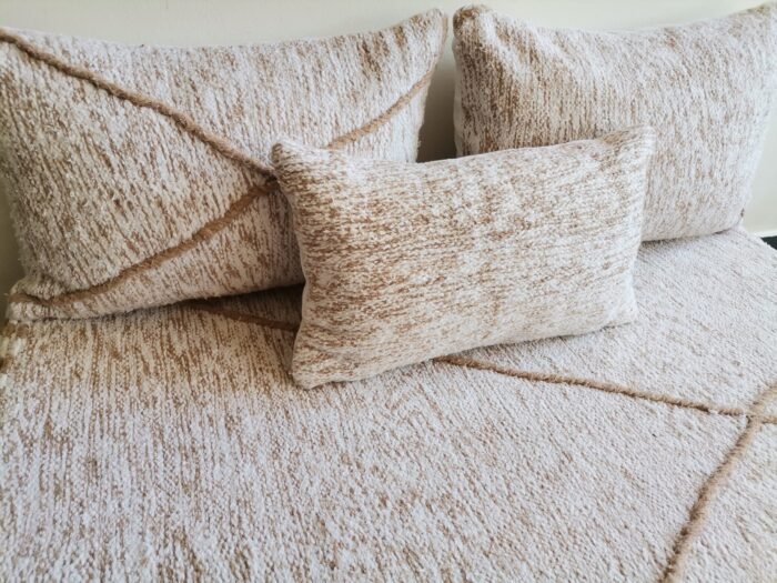 Close-up of cream cushions with beige patterns – Moroccan handmade covers for boho-chic decor