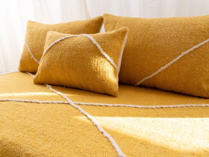 Close-up of plain yellow cushions on Moroccan sofa – artisan handmade pillows for boho or modern style living rooms