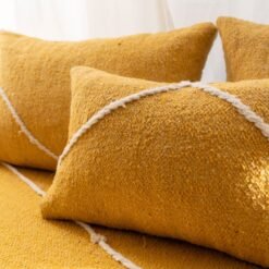 Close-up of plain yellow cushions – Moroccan handmade covers for warm, minimalist living rooms