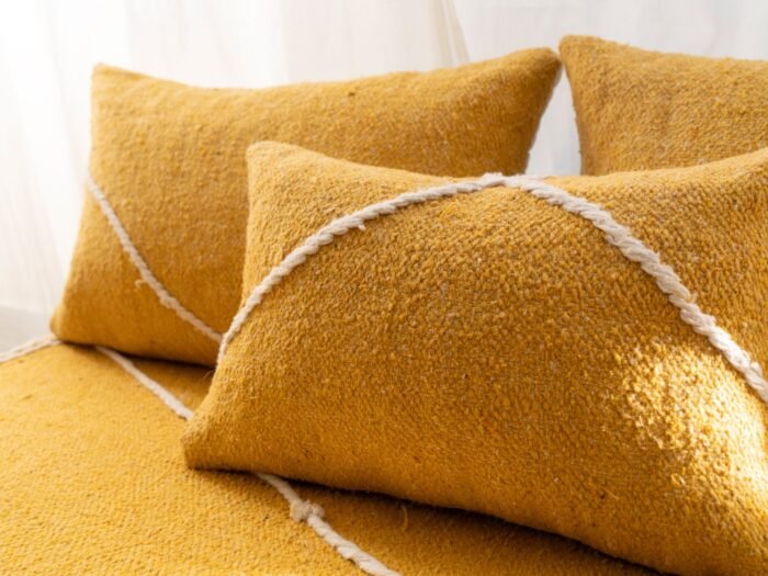 Close-up of plain yellow cushions – Moroccan handmade covers for warm, minimalist living rooms