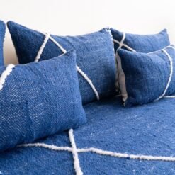 Close-up of blue cushions on Moroccan floor sofa – artisan pillow covers for soft, cozy, and bohemian living room design
