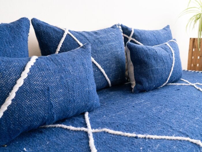 Close-up of blue cushions on Moroccan floor sofa – artisan pillow covers for soft, cozy, and bohemian living room design