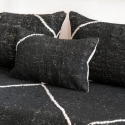 Close-up of black cushions on Moroccan floor couch – handcrafted pillow covers for bold and modern living room styling