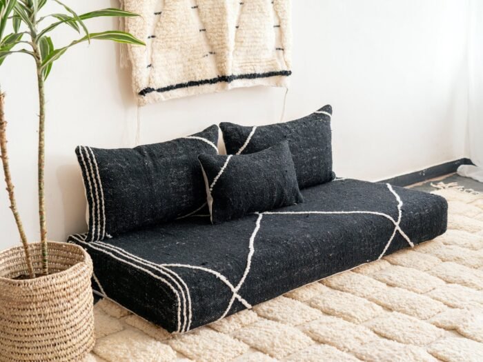 Left angle of black Moroccan floor couch – handmade low seating with plain cushions, ideal for modern and luxurious home decor