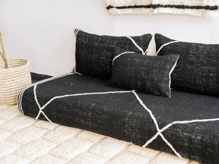 Right side view of handcrafted black Moroccan floor sofa – artisan low seating with cushion cover set for bold and elegant interiors