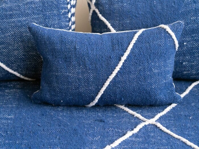 Close-up of blue cushions on Moroccan floor sofa – artisan pillow covers for soft, cozy, and bohemian living room design