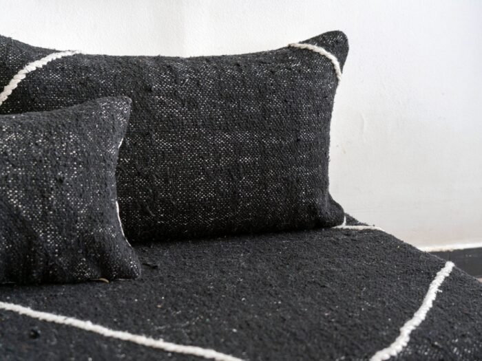 Close-up of black cushions on Moroccan floor couch – handcrafted pillow covers for bold and modern living room styling