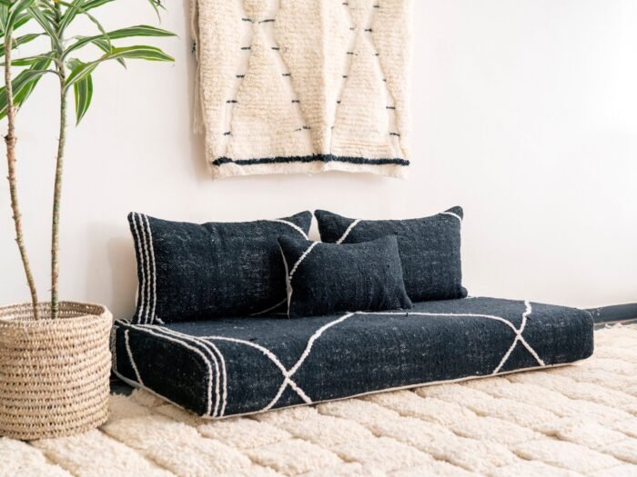 Left angle of black Moroccan floor couch – handmade low seating with plain cushions, ideal for modern and luxurious home decor