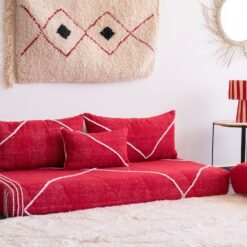 Left angle of handcrafted red low sofa – Moroccan seating for warm and colorful home decor