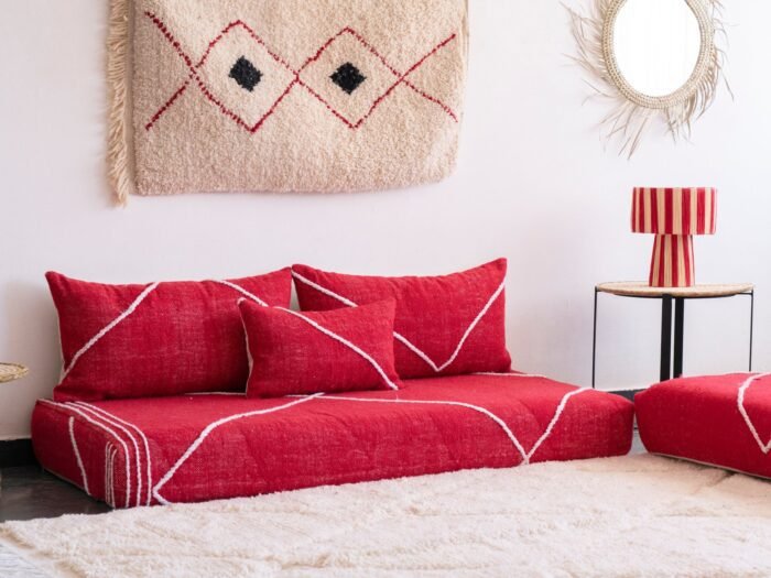 Left angle of handcrafted red low sofa – Moroccan seating for warm and colorful home decor