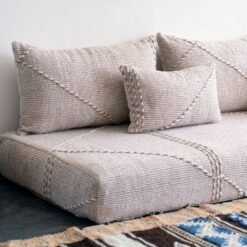 Close-up of handmade beige and white pillows – Moroccan cushion covers for elegant boho and contemporary interiors
