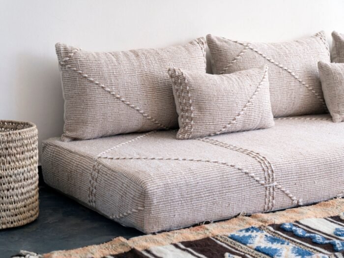 Close-up of handmade beige and white pillows – Moroccan cushion covers for elegant boho and contemporary interiors