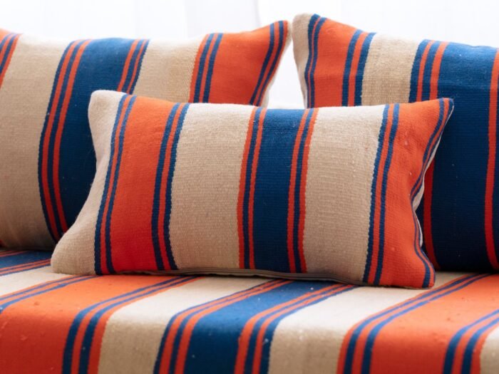 Close-up of cushions from Moroccan wool floor couch in Cream with Blue and Orange Stripes – artisan pillow covers for cozy and stylish home decor