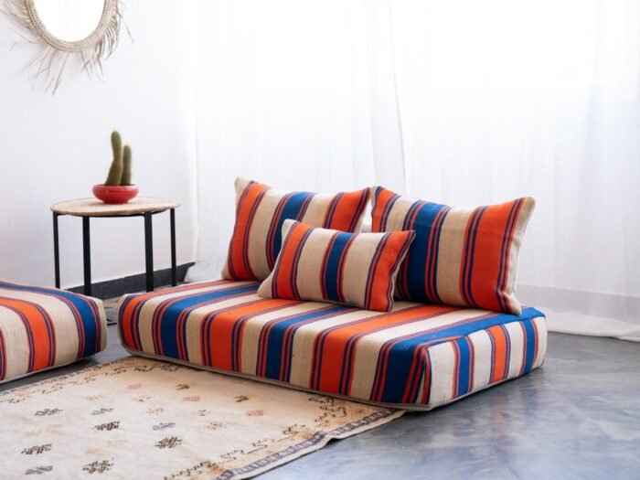 Right side view of Cream with Blue and Orange Stripes Moroccan wool floor sofa – handcrafted boho low seating with plain cushions for relaxed interiors