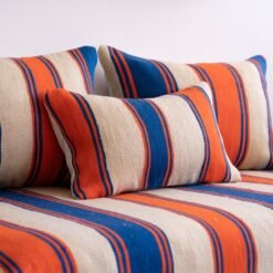 Close-up of cushions from Moroccan wool floor couch in Cream with Blue and Orange Stripes – artisan pillow covers for cozy and stylish home decor