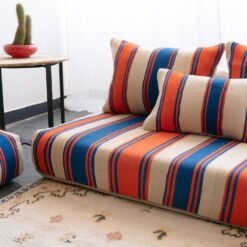 Right side view of Cream with Blue and Orange Stripes Moroccan wool floor sofa – handcrafted boho low seating with plain cushions for relaxed interiors