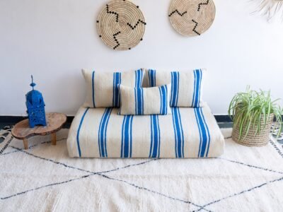 Top view of Moroccan wool couch in cream with soft blue lines – handmade for serene, boho-chic interiors