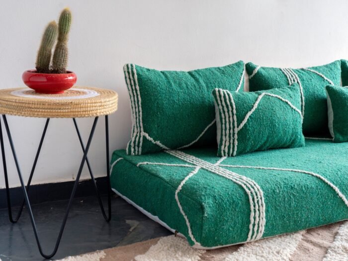 Close-up of plain green cushions on Moroccan sofa – handwoven covers perfect for modern and natural-inspired homes