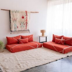 Handwoven orange Moroccan floor couch with minimalist cushions – ideal for boho-chic or eclectic living room decor