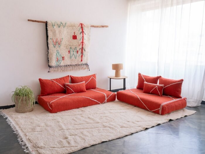 Handwoven orange Moroccan floor couch with minimalist cushions – ideal for boho-chic or eclectic living room decor