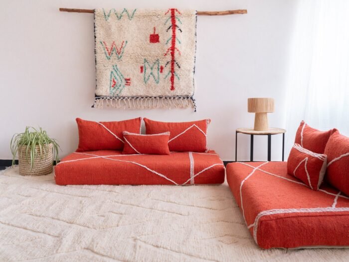 Right angle of orange Moroccan floor sofa – handcrafted warm-toned seating for bohemian and lively interiors