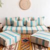 Main image of Moroccan floor sofa in cream with turquoise stripes – artisan handwoven wool couch for boho and coastal-style interiors