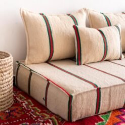 Top image of Moroccan wool floor seating in cream with red and green – ideal for colorful, warm interiors