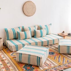 Left side image of Moroccan floor seating with turquoise striped pattern on cream – handmade wool low sofa